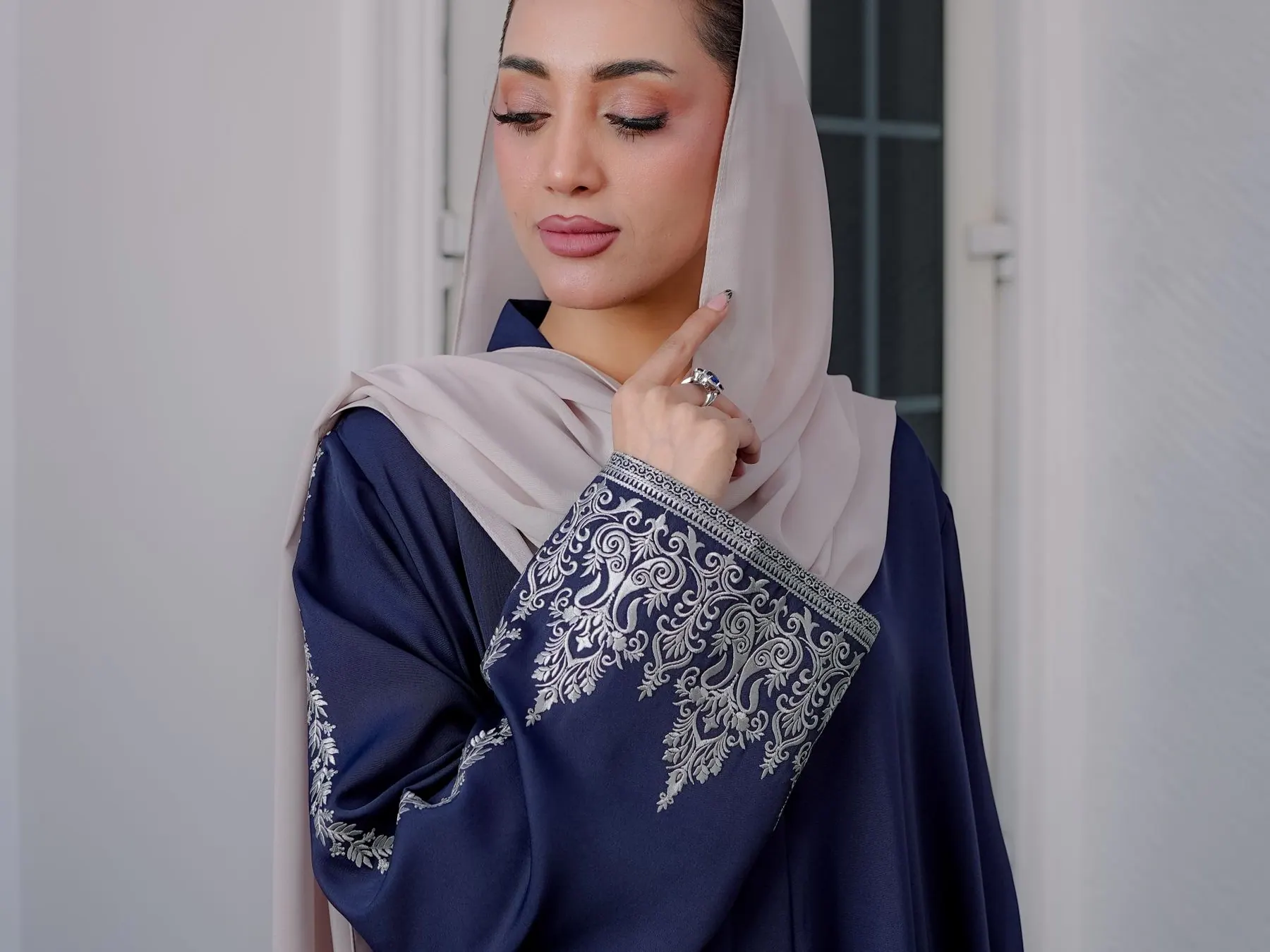 Woman in a detailed modest outfit and hijab