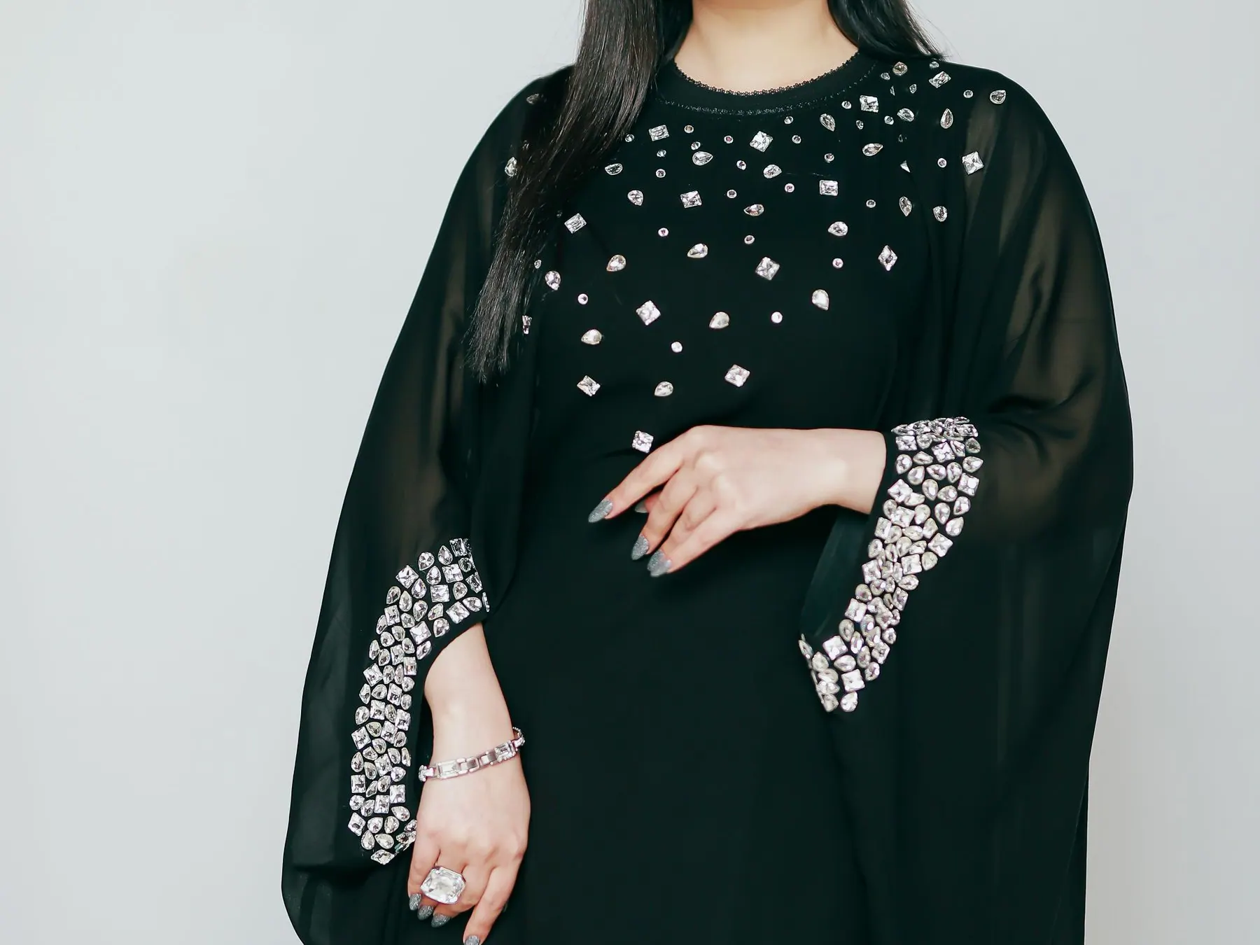 Woman posing in an ornate black abaya